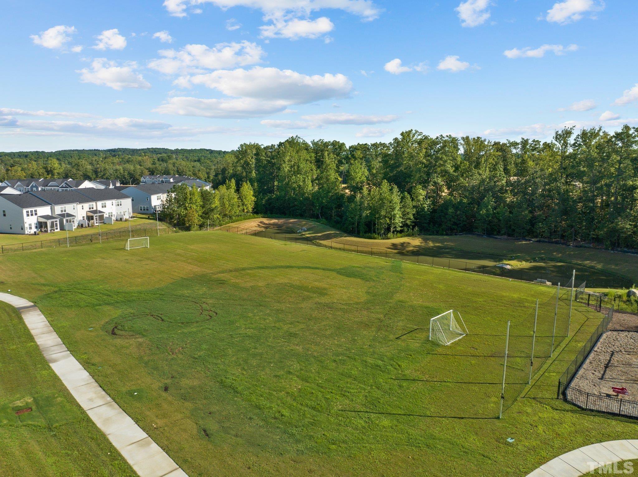 5106 Anamosa Street Raleigh, NC 27610 - Photo 37 of 49 a view of a swimming pool with an outdoor seating and yard