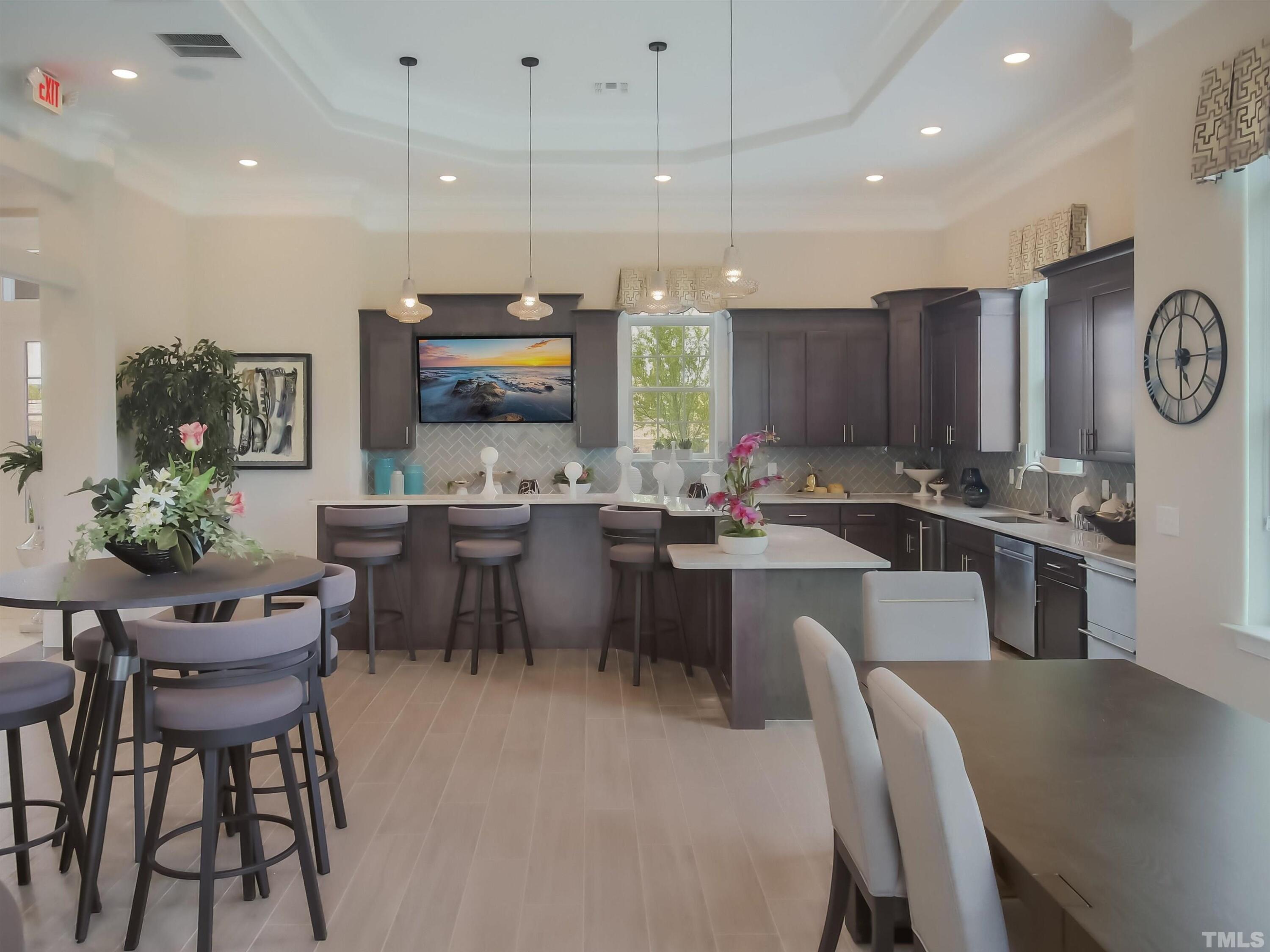 5106 Anamosa Street Raleigh, NC 27610 - Photo 45 of 49 a kitchen with a table chairs refrigerator and microwave