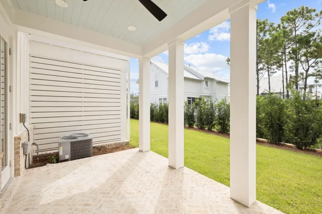 a view of a porch with furniture and garden
