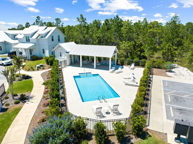 an aerial view of a house with a yard and lake view