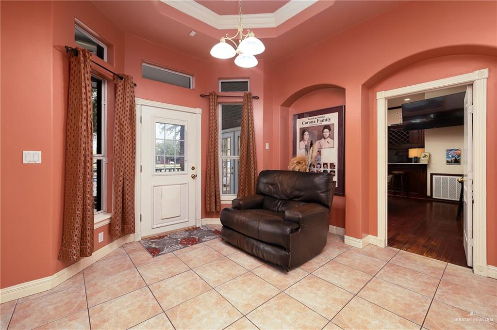 23725 North Val Verde Road Edinburg, TX 78542 - Photo 13 of 36 a living room with furniture and a chandelier
