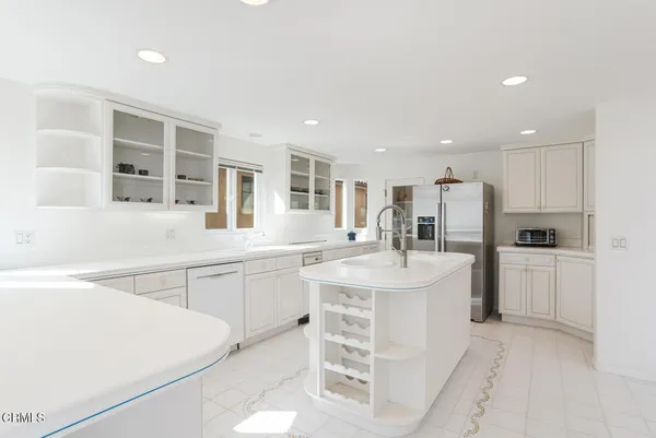 a kitchen with a sink and white cabinets