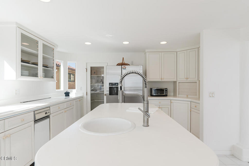 5331 Wavecrest Way Oxnard, CA 93035 - Photo 18 of 60 a kitchen with kitchen island a sink appliances and cabinets