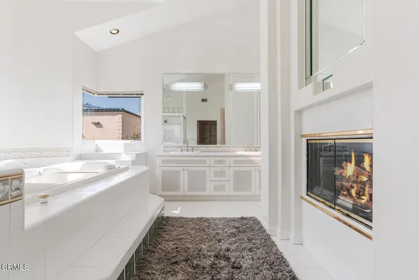 a large white kitchen with cabinets