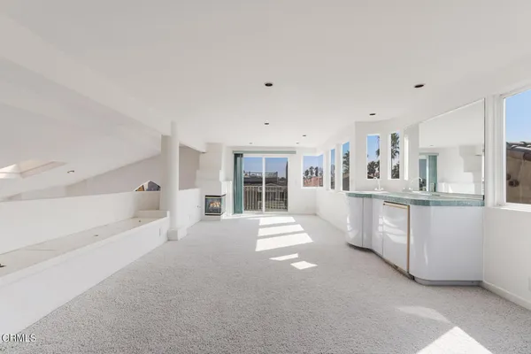 a kitchen with a sink a counter and chairs