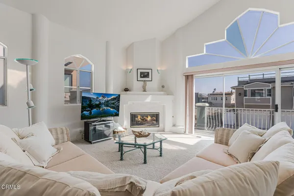 a living room with furniture a large window and chairs