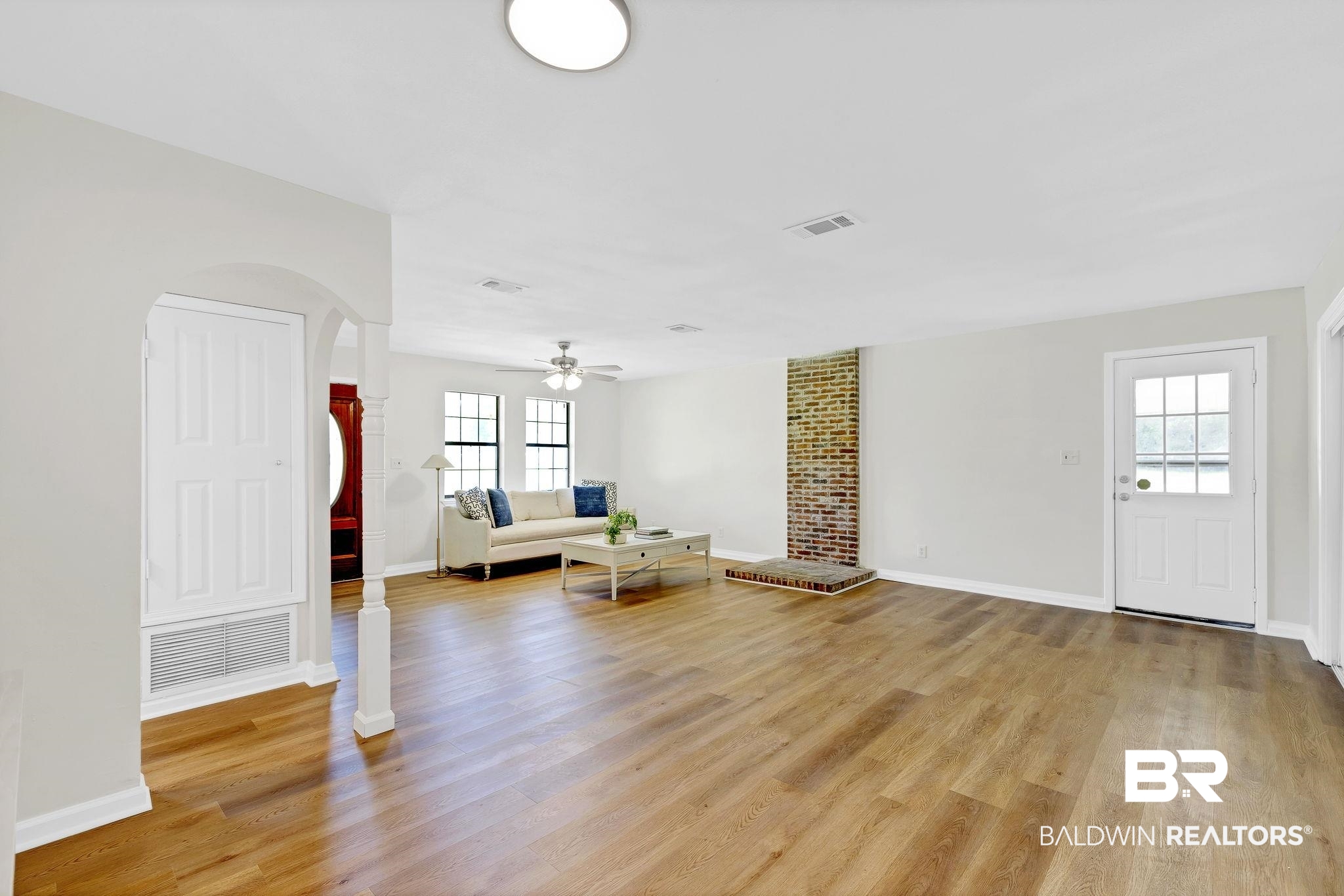 11964 Stroh Road Daphne, AL 36527 - Photo 14 of 58 Unfurnished living room with light wood-style floors, visible vents, baseboards, and a ceiling fan