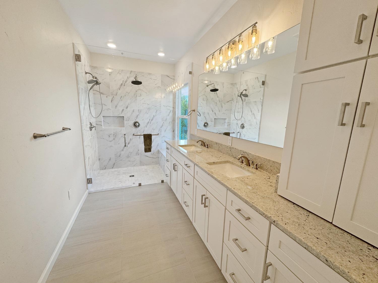 10095 Birchville Road Nevada City, CA 95959 - Photo 8 of 38 a large bathroom with a granite countertop sink mirror and a shower