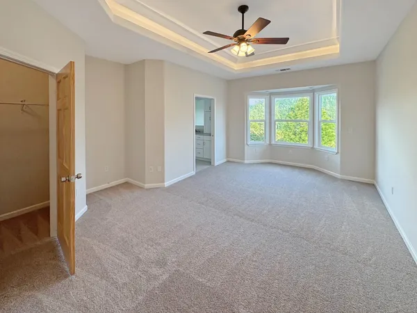 a view of a room with a ceiling fan and a window
