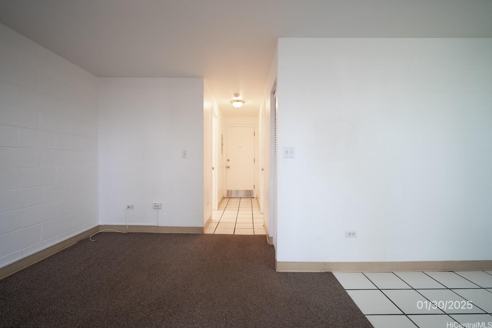 1654 Liholiho Street, Unit 9 Honolulu, HI 96822 - Photo 11 of 16 an empty room with wooden floor and windows