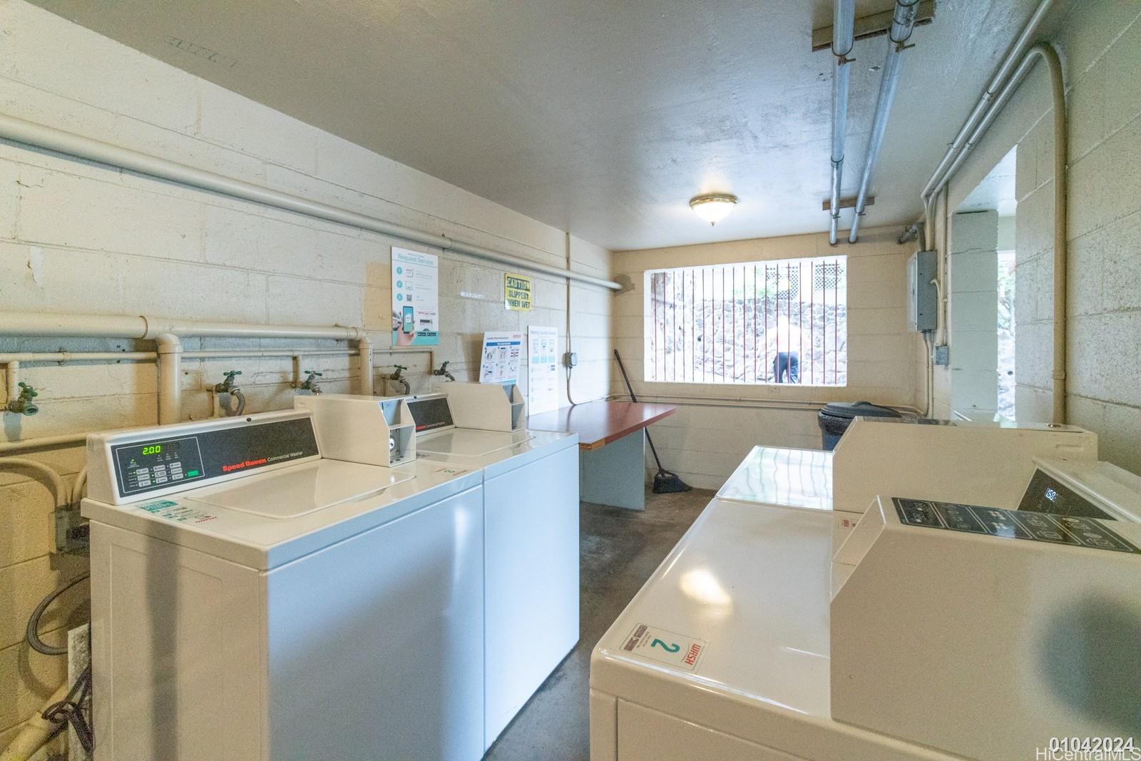 1654 Liholiho Street, Unit 9 Honolulu, HI 96822 - Photo 3 of 16 a kitchen with a sink a counter top space and living room area