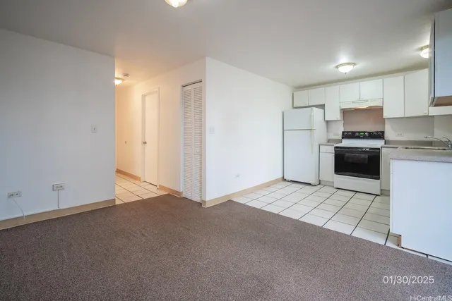a view of a kitchen with stainless steel appliances granite countertop a refrigerator a stove top oven a sink and dishwasher