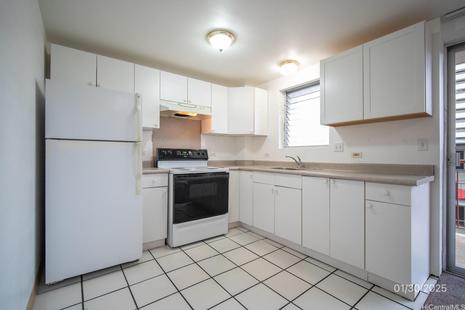 1654 Liholiho Street, Unit 9 Honolulu, HI 96822 - Photo 6 of 16 a kitchen with a refrigerator sink and cabinets