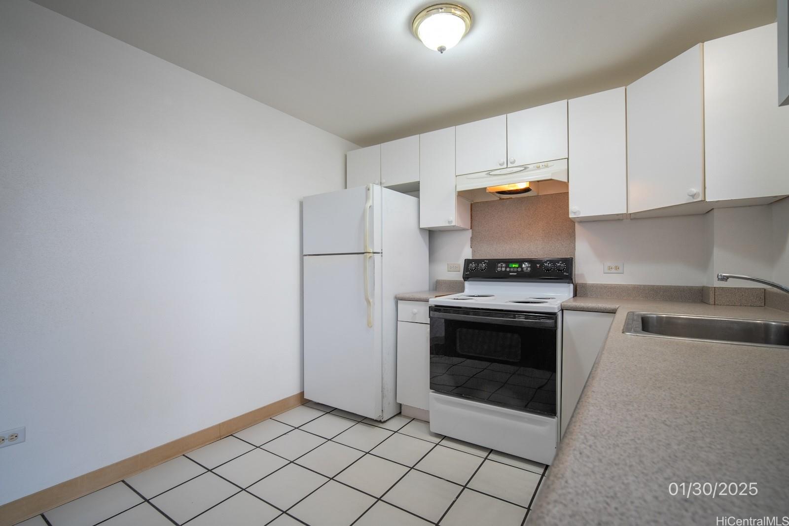 1654 Liholiho Street, Unit 9 Honolulu, HI 96822 - Photo 7 of 16 a kitchen with cabinets and steel stainless steel appliances