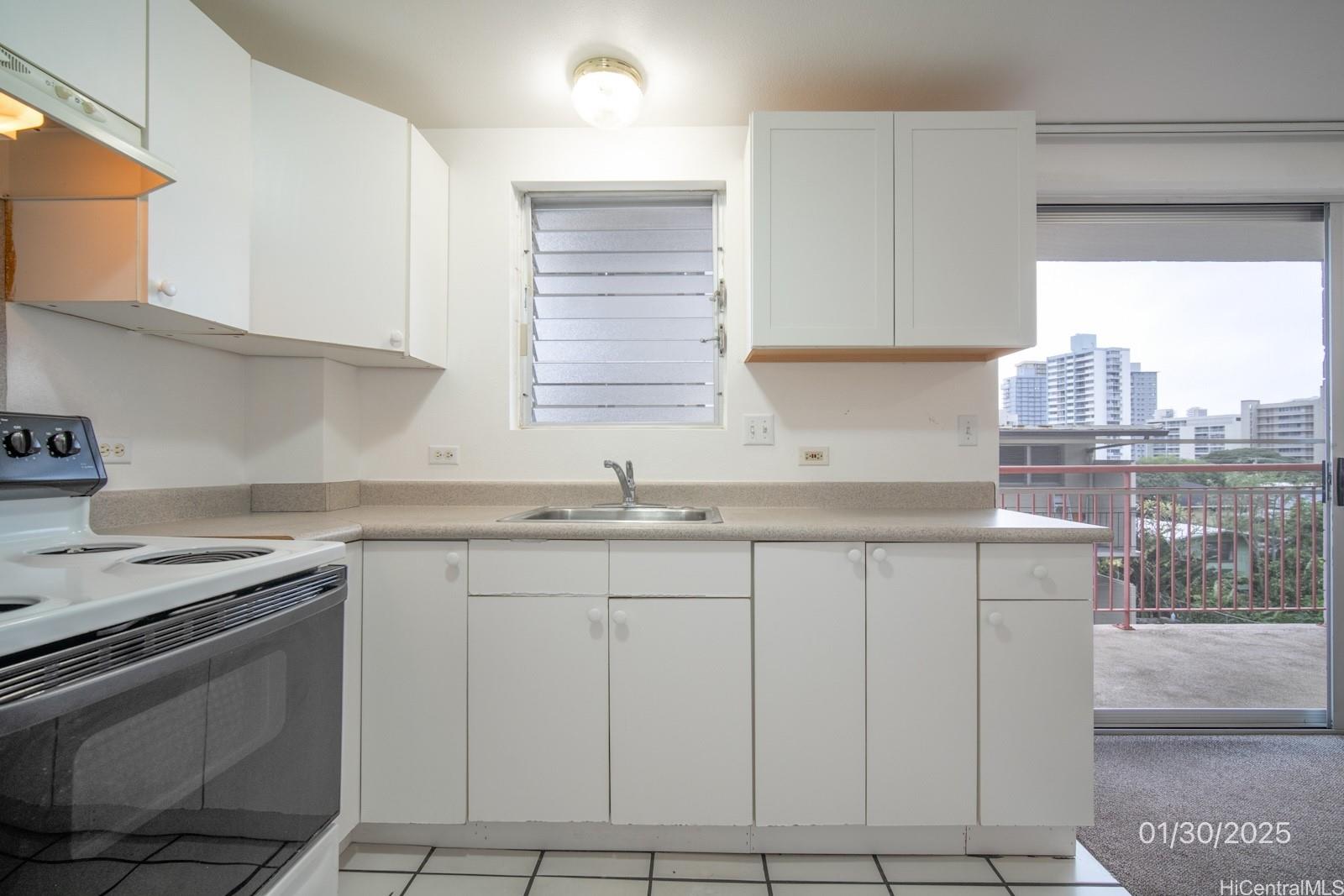 1654 Liholiho Street, Unit 9 Honolulu, HI 96822 - Photo 8 of 16 a kitchen with stainless steel appliances granite countertop a sink stove and cabinets