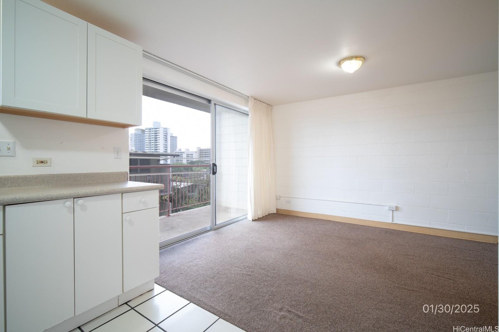 1654 Liholiho Street, Unit 9 Honolulu, HI 96822 - Photo 10 of 16 a kitchen with granite countertop white cabinets and white appliances