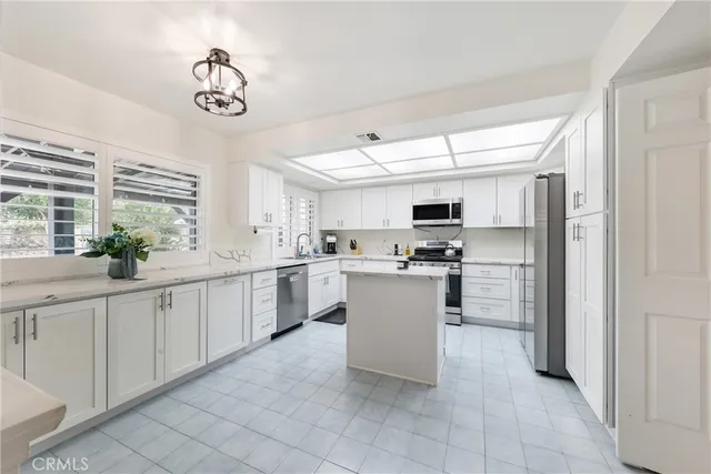 a kitchen with white cabinets and white appliances