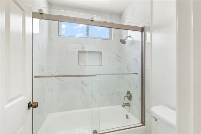 a bathroom with a bathtub a toilet and a shower