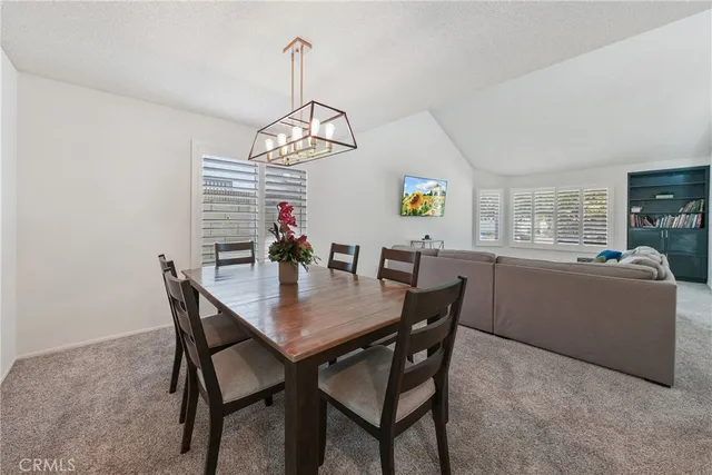 a view of a dining room with furniture wooden floor and chandelier