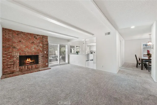 a view of an empty room with furniture and a fireplace