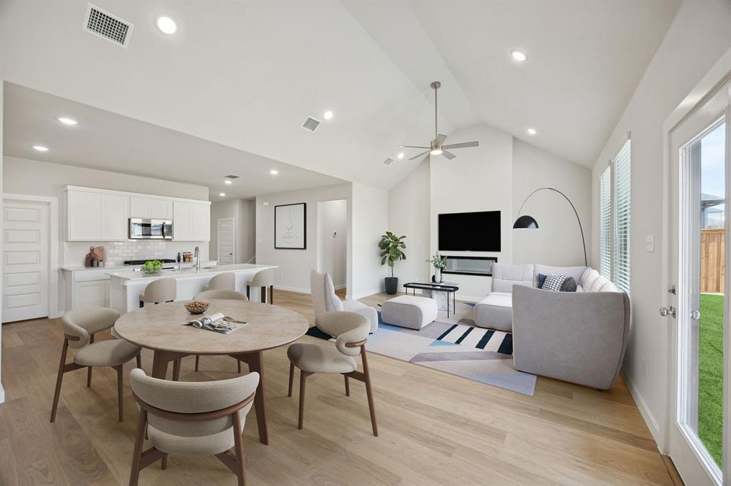 1472 Companero Street Haslet, TX 76052 - Photo 39 of 40 a living room with furniture kitchen view and a flat screen tv