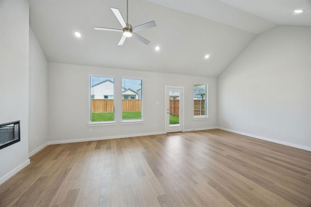 1472 Companero Street Haslet, TX 76052 - Photo 13 of 40 an empty room with window and wooden floor