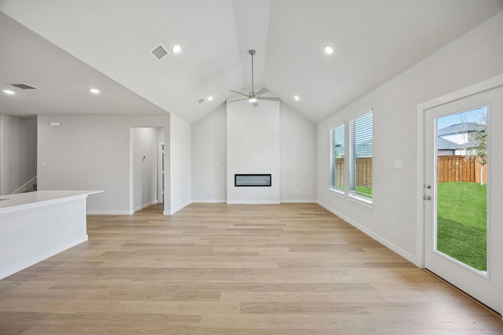 1472 Companero Street Haslet, TX 76052 - Photo 14 of 40 a view of an empty room with a window and wooden floor