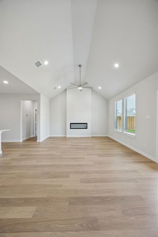 1472 Companero Street Haslet, TX 76052 - Photo 15 of 40 a view of an empty room with wooden floor and a window