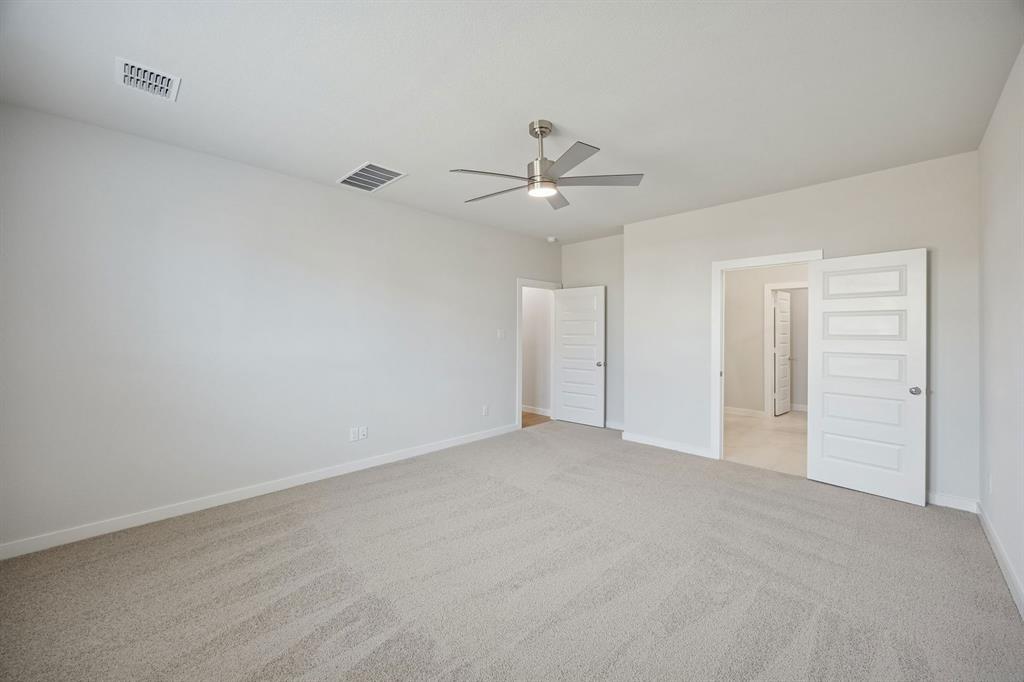 1472 Companero Street Haslet, TX 76052 - Photo 18 of 40 a view of an empty room with a ceiling fan