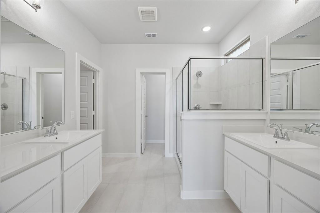 1472 Companero Street Haslet, TX 76052 - Photo 19 of 40 a bathroom with double vanity sink and a mirror