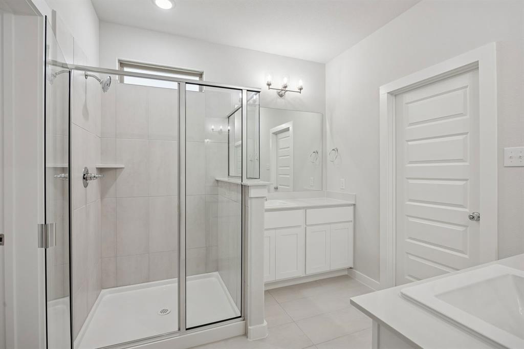 1472 Companero Street Haslet, TX 76052 - Photo 20 of 40 a bathroom with a shower sink and mirror