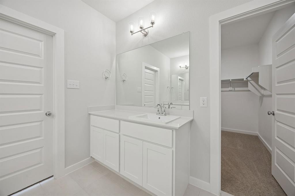 1472 Companero Street Haslet, TX 76052 - Photo 21 of 40 a bathroom with a sink and a mirror