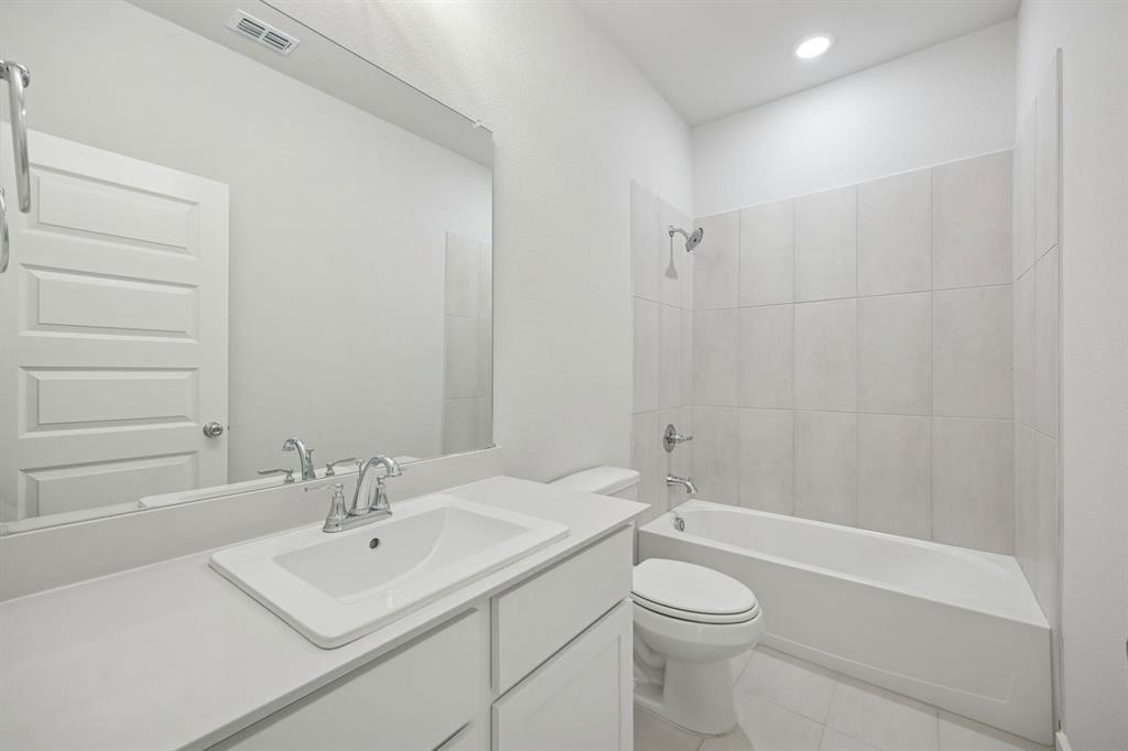 1472 Companero Street Haslet, TX 76052 - Photo 32 of 40 a bathroom with a sink a toilet and shower