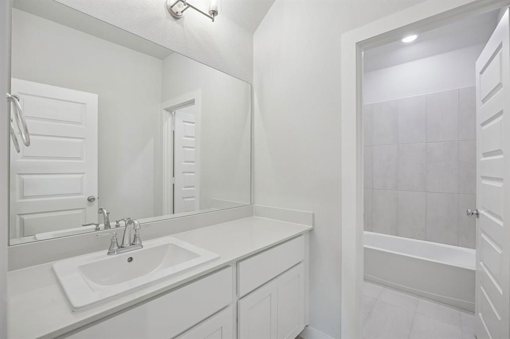 1472 Companero Street Haslet, TX 76052 - Photo 33 of 40 a bathroom with a sink and a mirror