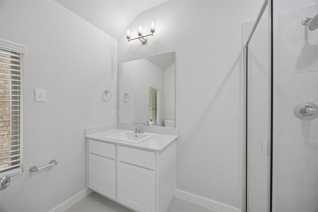 1472 Companero Street Haslet, TX 76052 - Photo 34 of 40 a bathroom with a sink a mirror and vanity