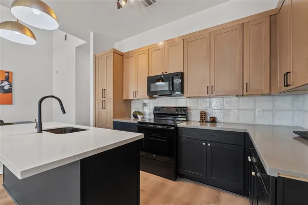a kitchen with a sink a stove and cabinets