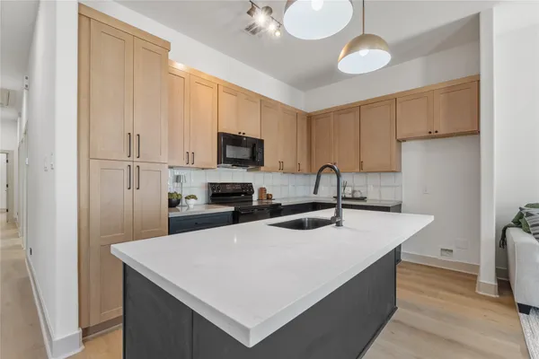 a kitchen with stainless steel appliances a sink stove and refrigerator