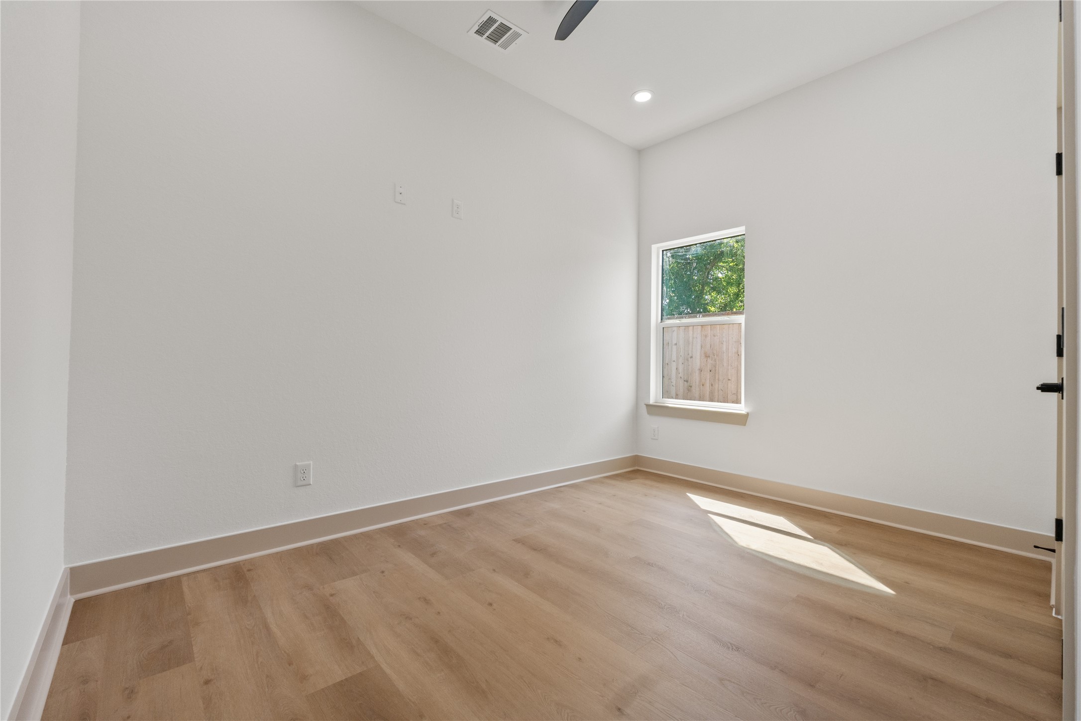 4214 Clover Street Houston, TX 77051 - Photo 17 of 25 an empty room with wooden floor and window