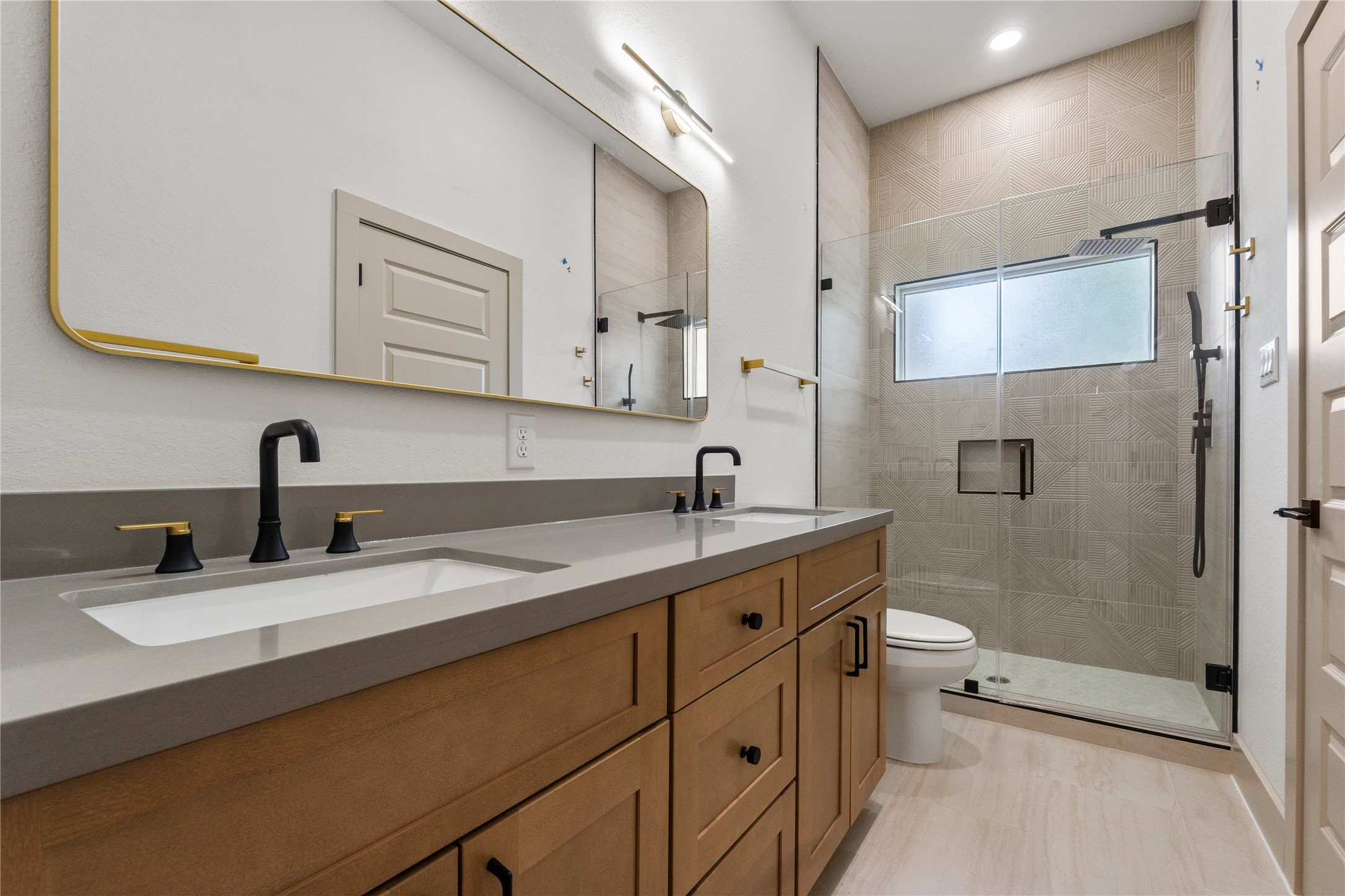 4214 Clover Street Houston, TX 77051 - Photo 21 of 25 a bathroom with a double vanity sink toilet and mirror