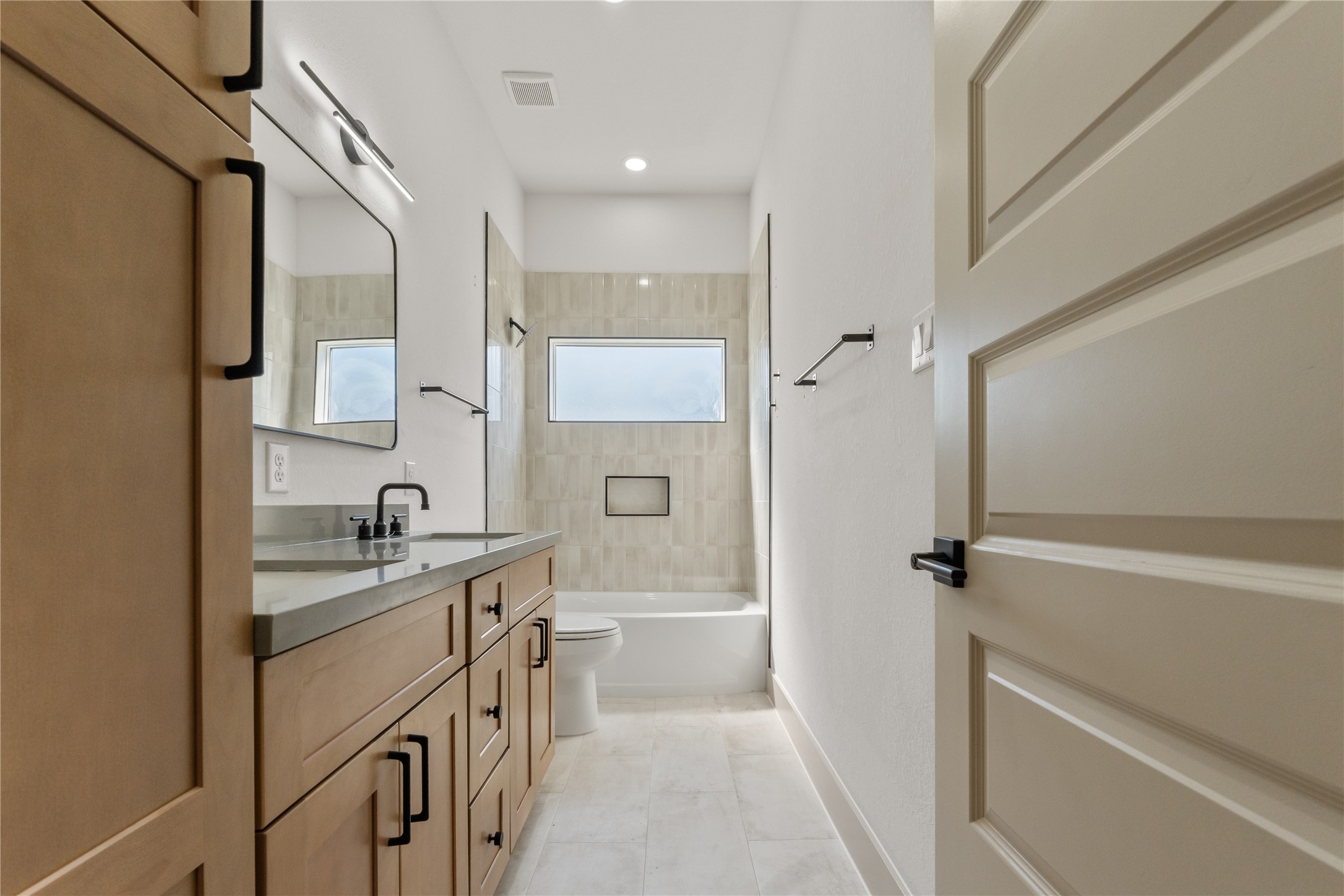 4214 Clover Street Houston, TX 77051 - Photo 22 of 25 a bathroom with a granite countertop sink a toilet and a shower