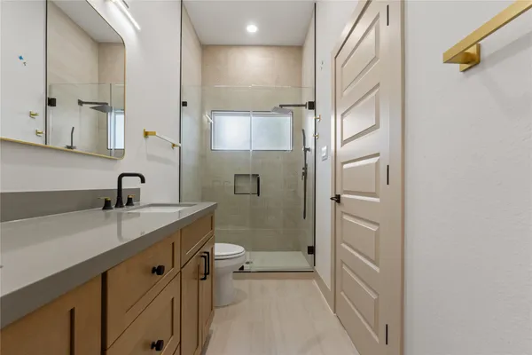 a view of a bathroom with a sink and mirror