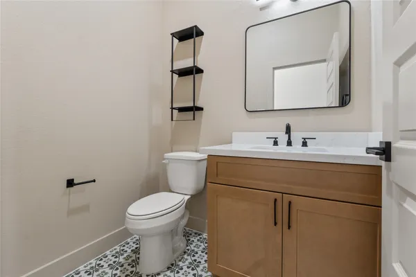 a bathroom with a toilet sink and mirror
