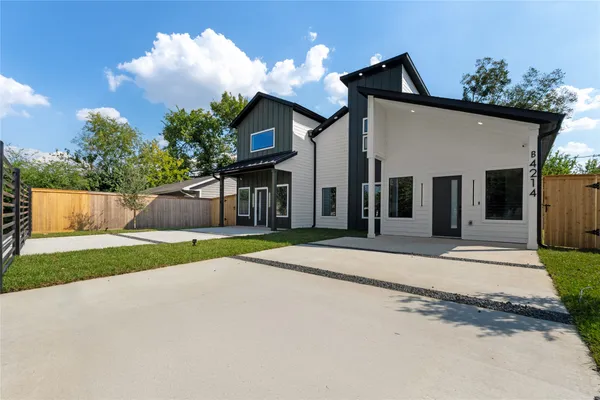 a view of a house with a yard and garage