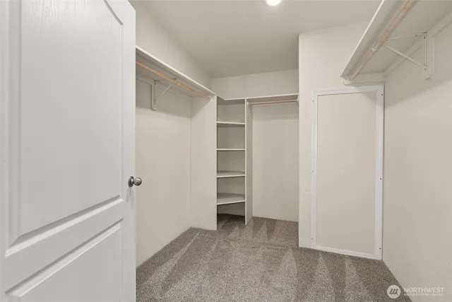 a bathroom with a granite countertop sink and a toilet