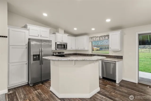 a kitchen with granite countertop a stove a sink and a granite counter tops