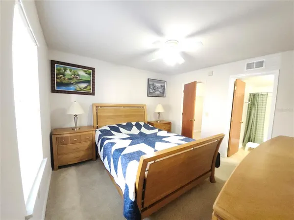 a bedroom with a bed and a couch