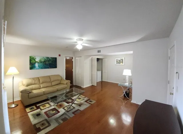 a bedroom with furniture and a wooden floor