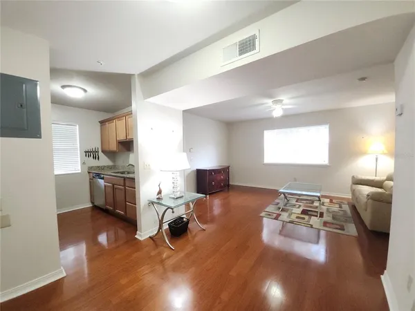 a living room with furniture and a wooden floor