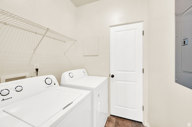 8215 Clear Rock Road, Unit 12 Eagle Mountain, UT 84005 - Photo 13 of 38 Laundry area featuring a wire shelving unit, wood-finish flooring, and a white paneled door with a black doorknob
