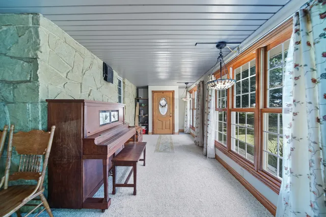 a view of a livingroom with furniture and a large window